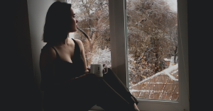 Depressed woman starring out a window