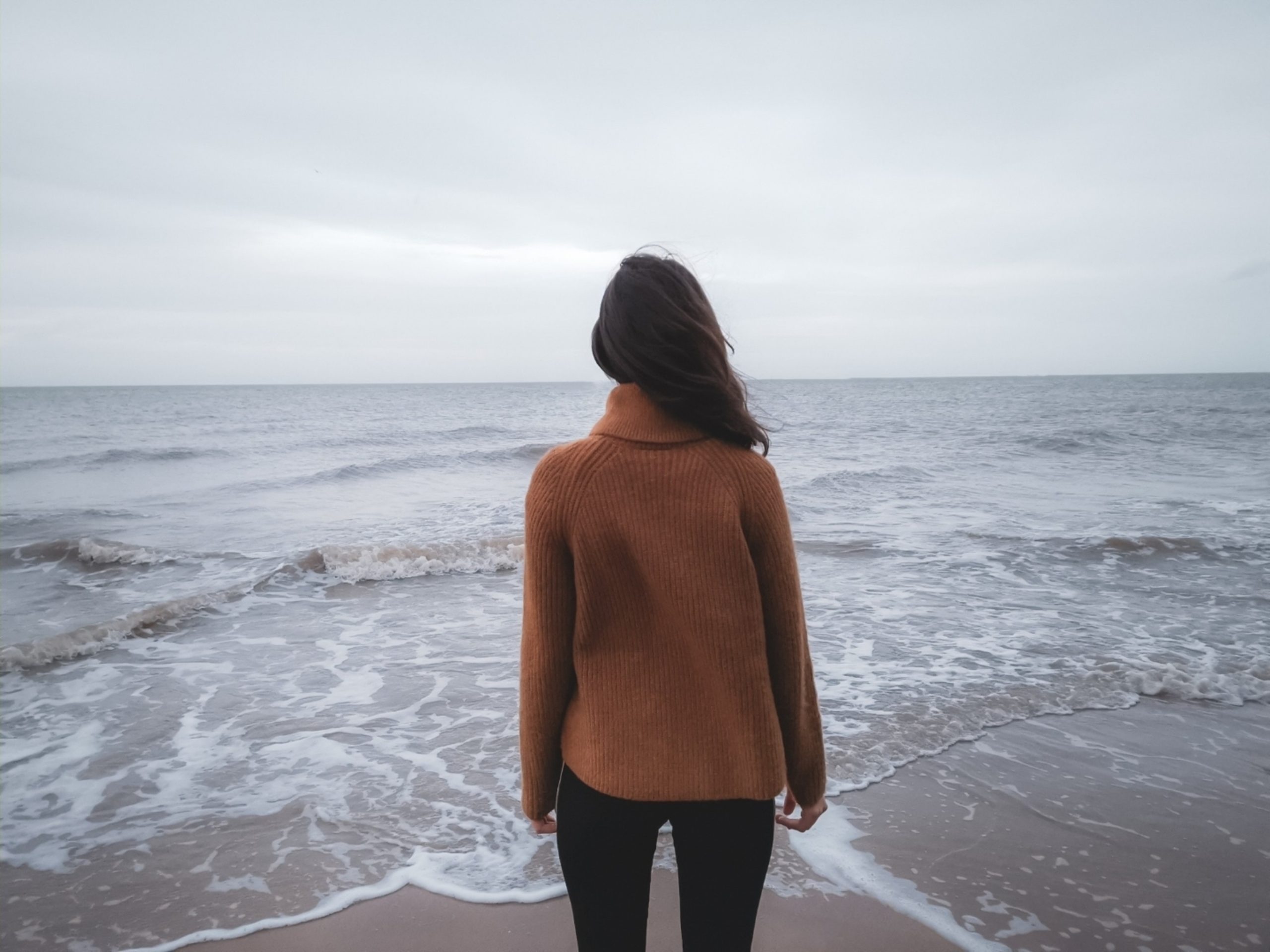 Woman with Anxiety staring out into the ocean